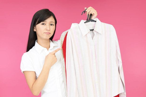 Dissatisfied Asian woman with clothes - Photo, image