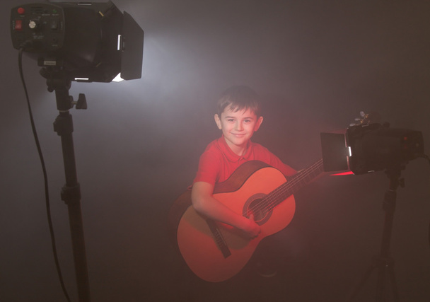 boy with acoustic guitar in fog - 写真・画像