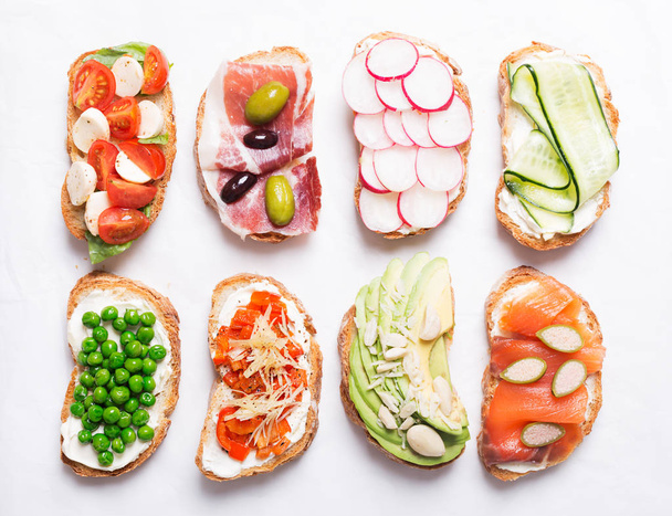 sandwiches or tapas prepared with bread and tasty ingredients. Could be nice food for healthy breakfast ot lunch - Foto, Imagem