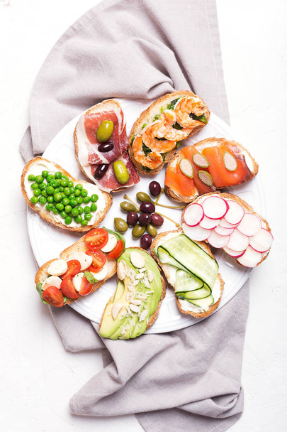 sandwiches or tapas prepared with bread and tasty ingredients. Could be nice food for healthy breakfast ot lunch - Foto, Imagem