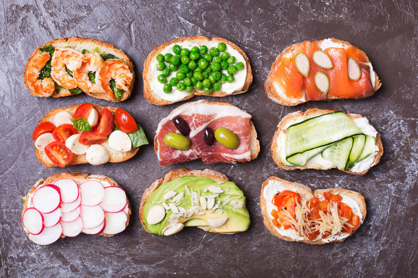 sandwiches or tapas prepared with bread and tasty ingredients. Could be nice food for healthy breakfast ot lunch - Foto, immagini