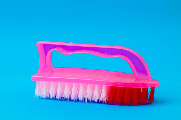 cleaning brush on a blue background - Fotó, kép