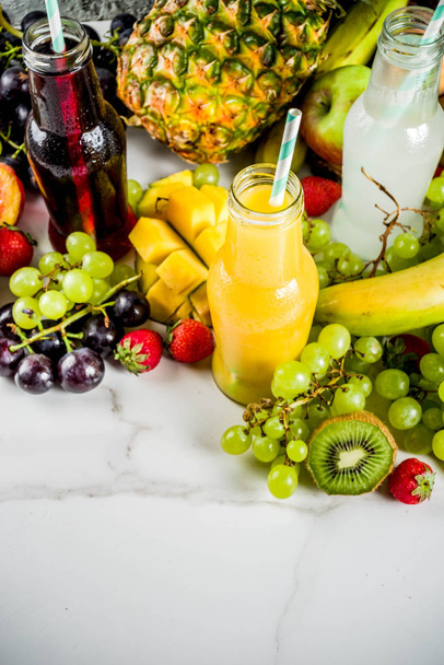 Different fruit juices smoothies concept, summer vitamins diet, with tropical fruits and berries on a light background, - Photo, image