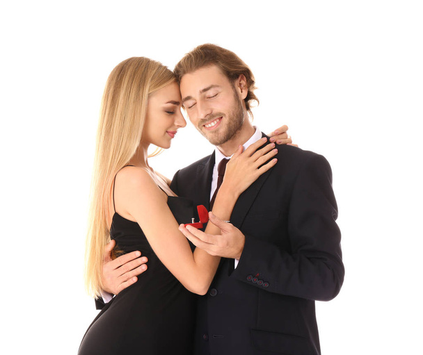 Young man proposing to his beloved on white background - Φωτογραφία, εικόνα