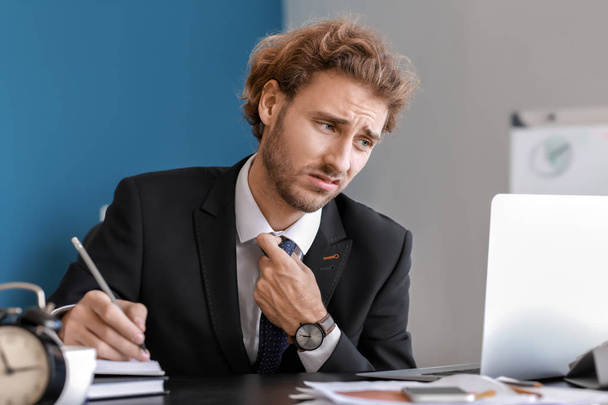 Stressed businessman trying to meet deadline in office - Photo, Image