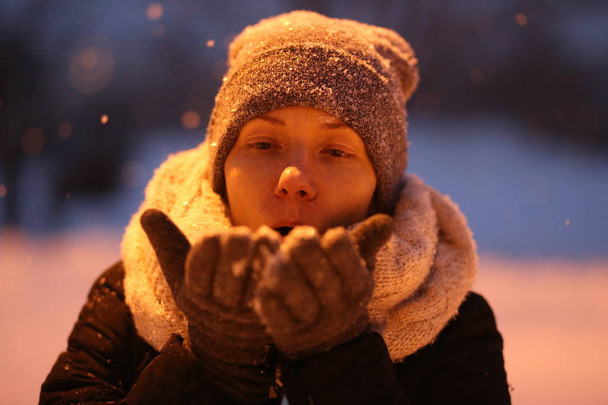 woman playing with snow outside season winter clothes - Foto, imagen