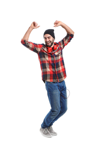 Pohledný mladý muž tančí na bílém pozadí - Fotografie, Obrázek