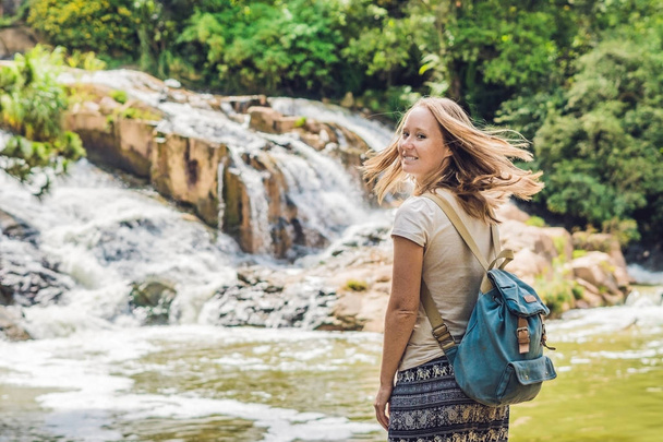 Young woman on the background of Beautiful Camly waterfall In Da Lat city - Foto, imagen