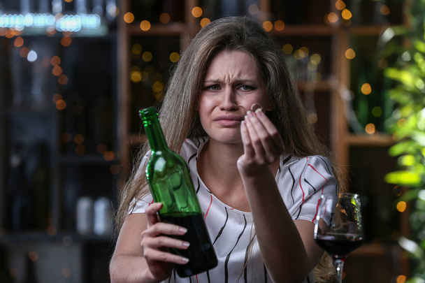 Depressed woman after divorce drinking alcohol in bar - Photo, Image