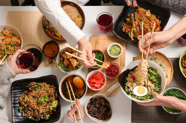 Τους φίλους που τρώνε νόστιμο κινέζικο φαγητό στο τραπέζι - Φωτογραφία, εικόνα