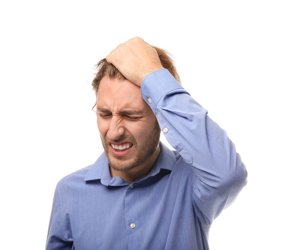 Young man suffering from headache on white background - Photo, Image