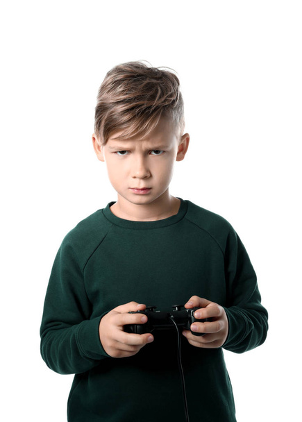 Emotional boy playing video game on white background - Fotó, kép