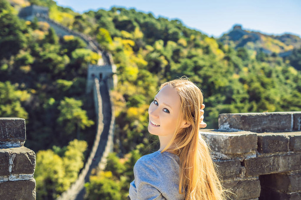 Happy cheerful joyful tourist woman at Great Wall of China having fun on travel smiling laughing and dancing during vacation trip in Asia. Girl visiting and sightseeing Chinese destination - Fotó, kép