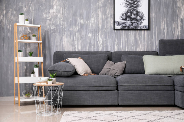 Stylish interior of living room with comfortable grey sofa - Фото, зображення