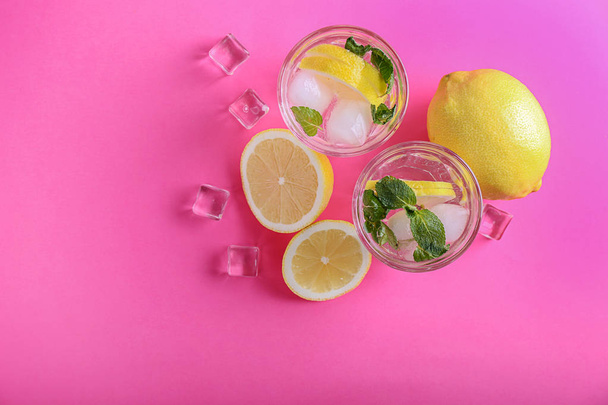 Vasos de sabrosa limonada fría sobre fondo de color - Foto, imagen