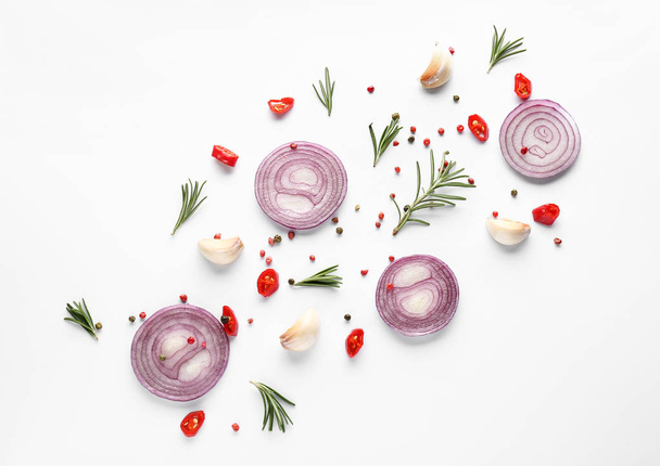 Cut onion and spices on white background, flat lay - Foto, Bild