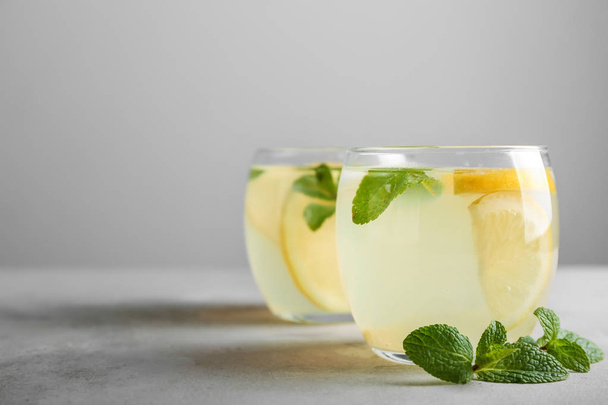Glasses of fresh lemonade on table - Φωτογραφία, εικόνα