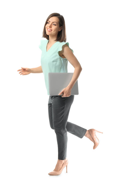 Walking young woman with laptop on white background - Photo, image