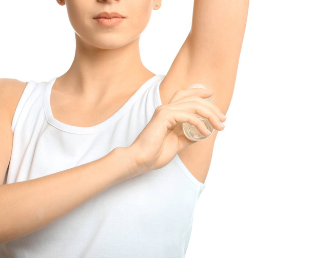 Beautiful young woman with deodorant on white background - Photo, Image