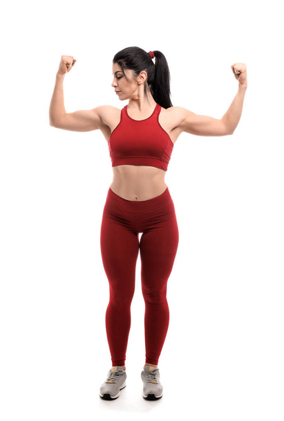 Mulher muscular desportiva no fundo branco
 - Foto, Imagem