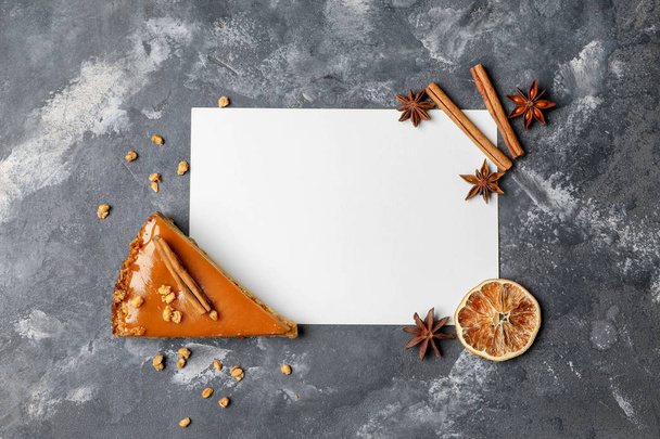 Empty paper sheet with piece of tasty pie on grey background - Photo, Image