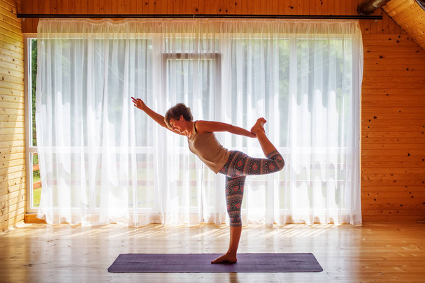 Caucasian woman is practicing yoga at studio - Foto, Bild