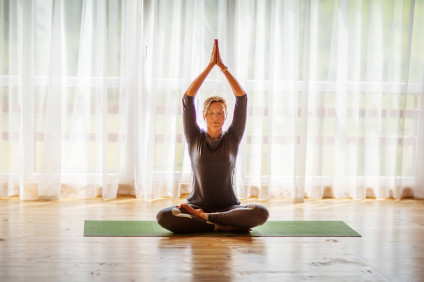 Caucasian woman is practicing yoga at studio - Foto, immagini