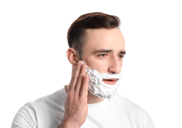 Handsome man with shaving foam on his face against white background - Foto, Imagen