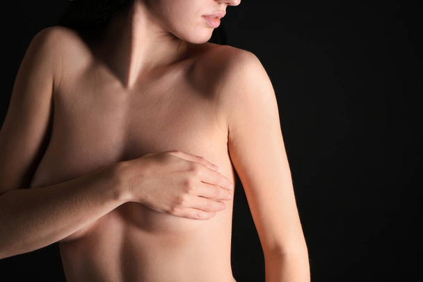 Young woman with beautiful breast on dark background - Zdjęcie, obraz