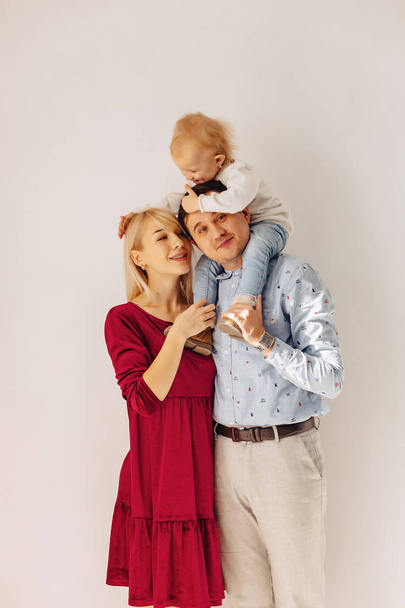 beautiful family with a small daughter, a simple background, happiness and joy in apartments - 写真・画像