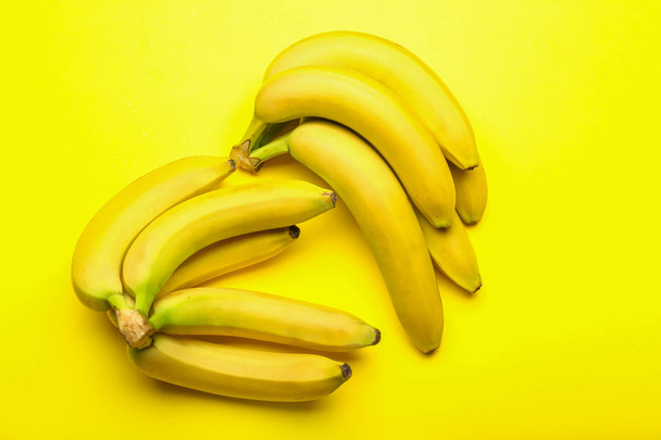 Ripe sweet bananas on color background - Fotografie, Obrázek