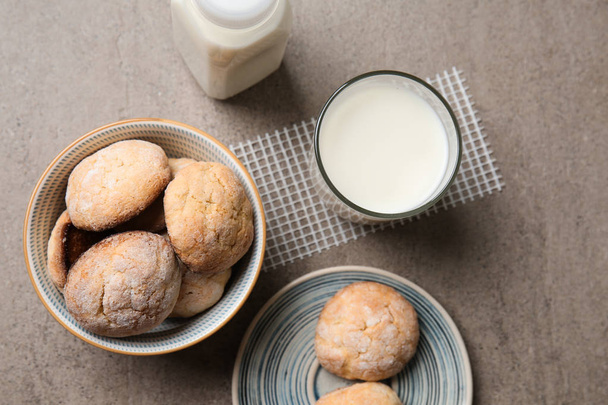 Tasty cookies with milk on grey table - 写真・画像