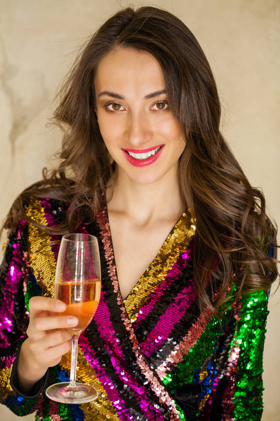 Portrait of a young happy girl in sexy dress with a glass of champagne - Foto, immagini