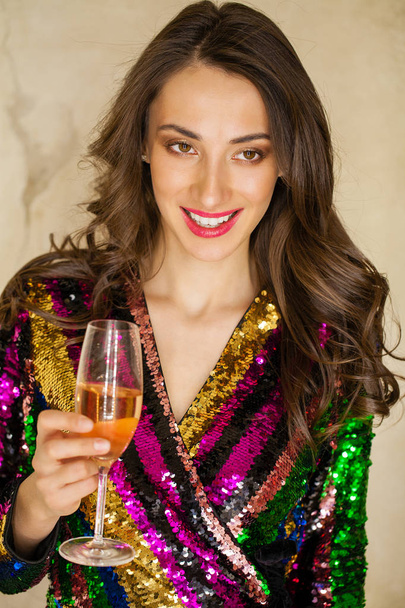 Portrait of a young happy girl in sexy dress with a glass of champagne - Fotografie, Obrázek