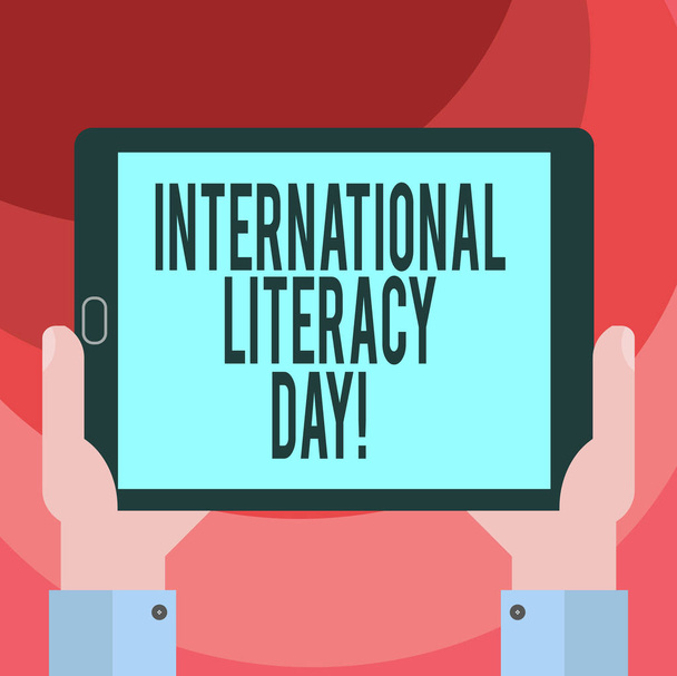 Text sign showing International Literacy Day. Conceptual photo Celebrated annual event on 8 of September Hu analysis Hand Holding Blank Screen Tablet Smartphone Display Unit photo - Photo, Image