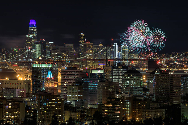 Oakland and San Francisco Downtowns with New Year's Eve 2019 Fireworks. Oakland Hills, Alameda County, California, USA. - Photo, Image