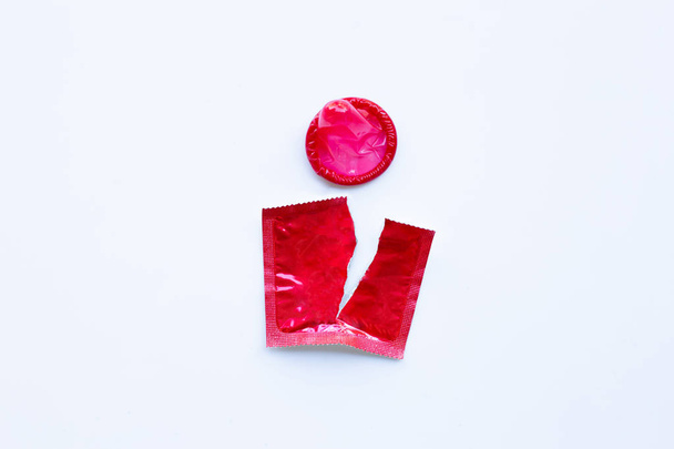 Red condom on white background. - Photo, image