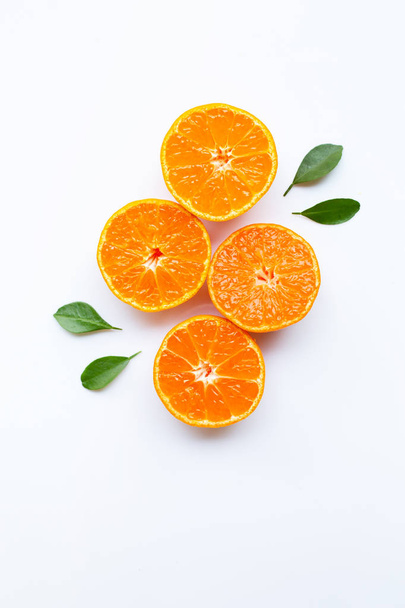 Orange fruits and green leaves on a white background. Top view - Foto, Bild