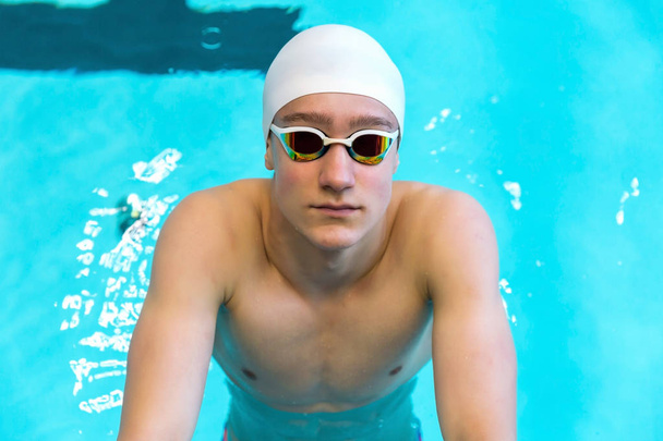 Portrait of a swimmer on the background of the pool. Pool background, copy space. - Foto, immagini