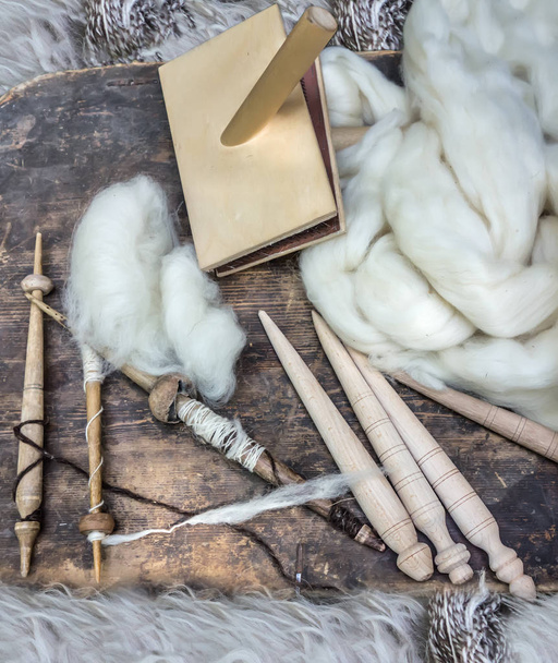 Tools for spinning wool and white sheep's wool.  Rural environment, rustic life. - Photo, Image