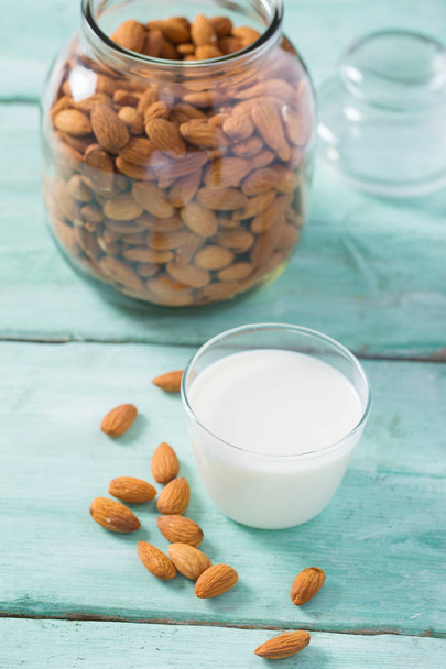 glass of almond milk on wooden surface - Φωτογραφία, εικόνα