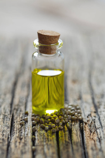 hemp seed oil on wooden surface - Фото, зображення