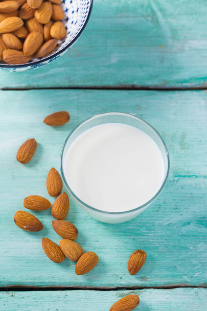 glass of almond milk on wooden surface - Photo, image
