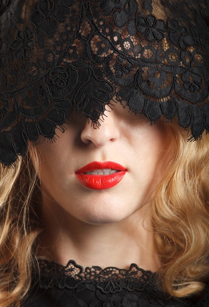 Beautiful woman with red lips and lace mask - 写真・画像