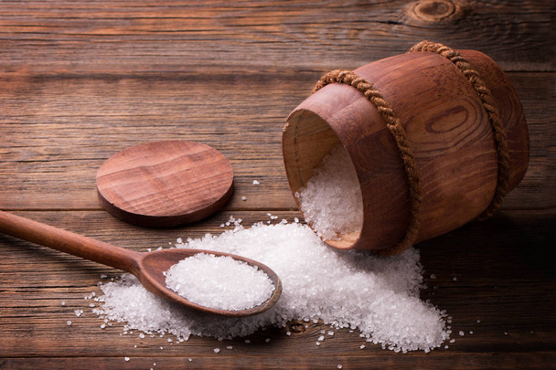 Sea salt in a keg on a wooden background - Photo, Image