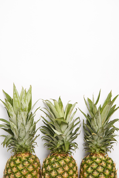 top view of organic fresh pineapples on white  background - Valokuva, kuva
