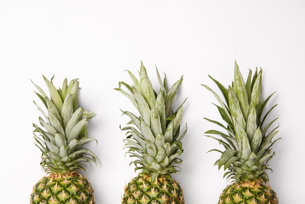 fresh, organic and tasty pineapples on white  background - Photo, image