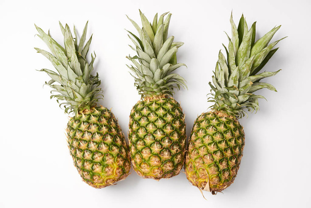 organic, juicy and sweet pineapples on white background - Valokuva, kuva