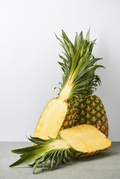 organic and sweet pineapple halves on white background - Zdjęcie, obraz