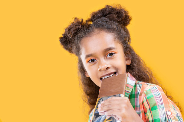 Joyful pleasant girl enjoying her sweet chocolate - Photo, Image